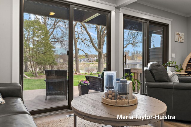 dining space with crown molding and wood finished floors