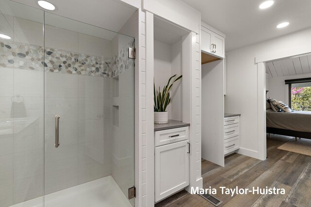 ensuite bathroom with visible vents, a stall shower, wood finished floors, ensuite bathroom, and recessed lighting