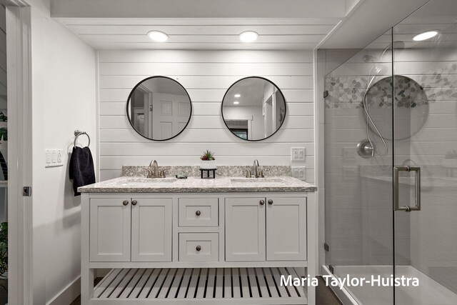 bathroom with double vanity, a sink, recessed lighting, and a shower stall