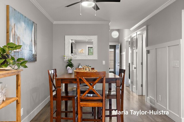 dining space with visible vents, ornamental molding, ceiling fan, and wood finished floors