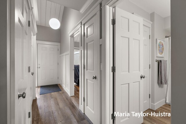 hallway with dark wood-type flooring and baseboards