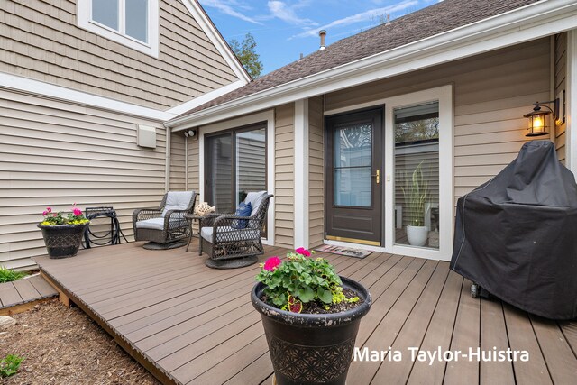 wooden deck featuring an outdoor living space and a grill