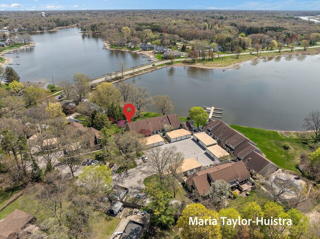birds eye view of property featuring a water view and a view of trees