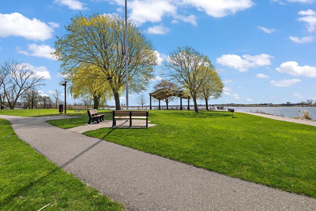 view of community featuring a lawn and a water view