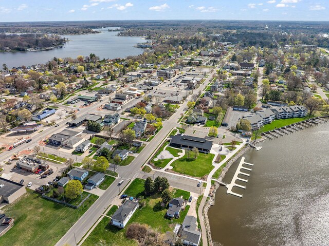 drone / aerial view with a water view and a residential view