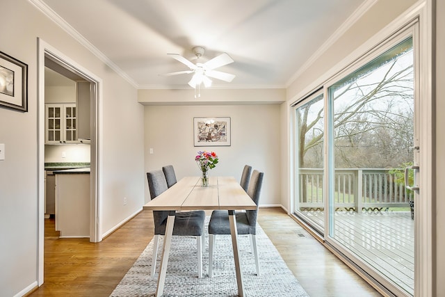 2204 Rivenoak Ct, Ann Arbor, MI 48103 - dining space featuring baseboards, ornamental molding, light wood-type flooring, and ceiling fan
