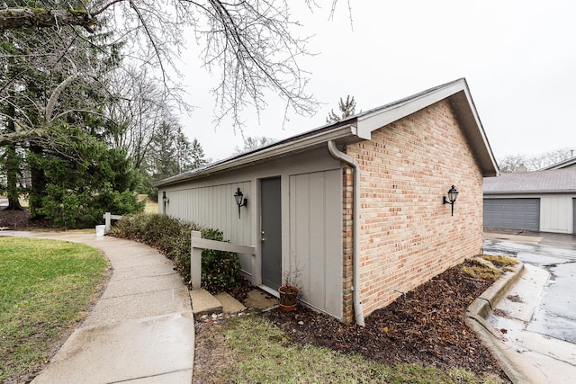 2204 Rivenoak Ct, Ann Arbor, MI 48103 - view of side of property with a garage, an outbuilding, and brick siding