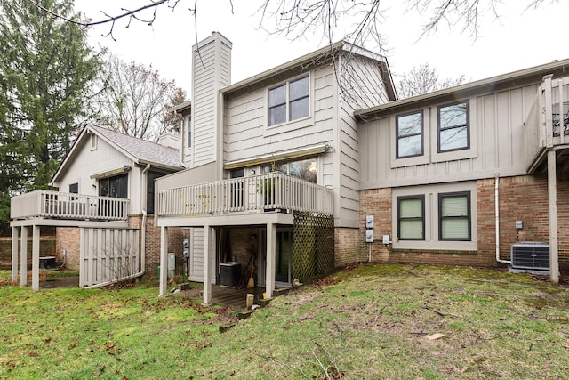 2204 Rivenoak Ct, Ann Arbor, MI 48103 - back of house with brick siding, central AC, a wooden deck, and a chimney