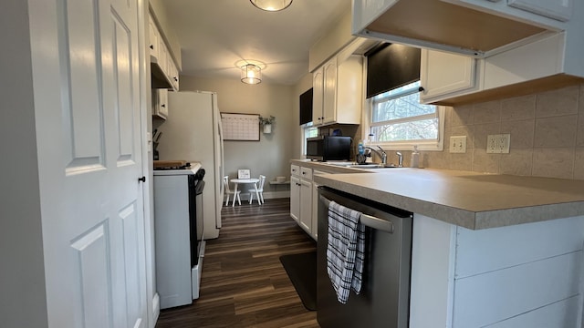 kitchen featuring dark wood finished floors, backsplash, white cabinetry, gas range, and stainless steel dishwasher