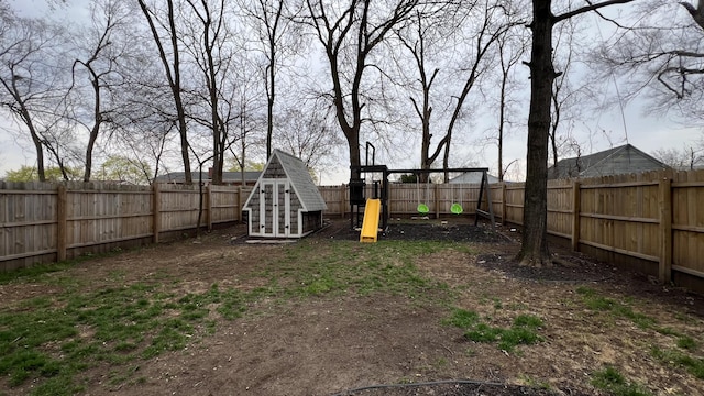 view of yard featuring a playground and a fenced backyard