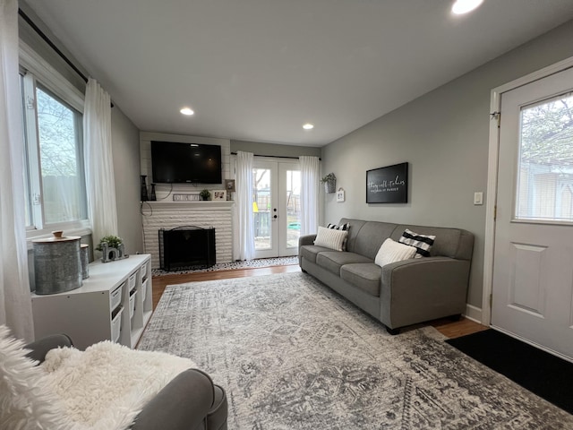 living area featuring recessed lighting, french doors, a wealth of natural light, and wood finished floors