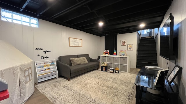 living area with wood finished floors and stairway
