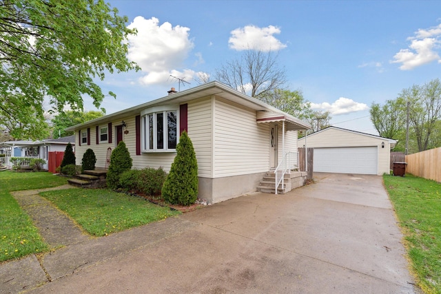 single story home with fence, a detached garage, an outbuilding, and a front yard