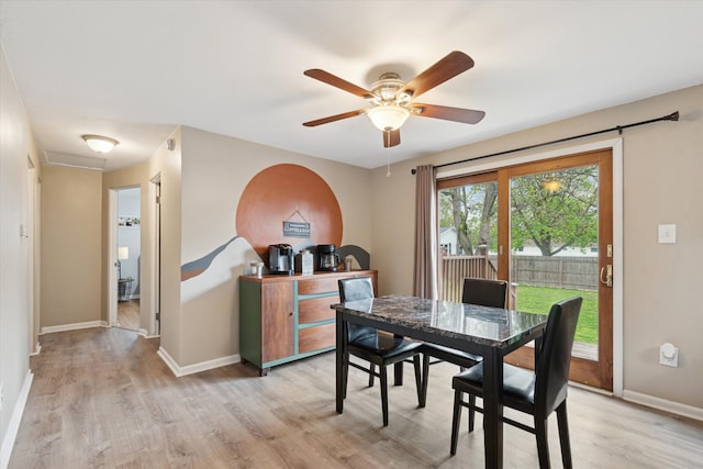 dining area with baseboards, ceiling fan, and light wood-style flooring