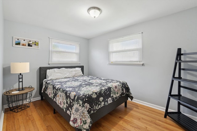 bedroom with baseboards and wood finished floors