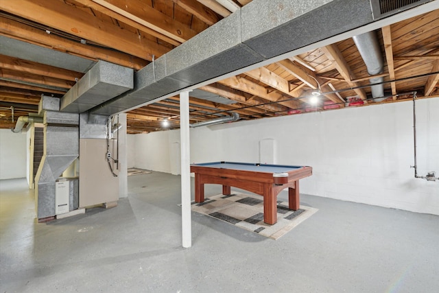 unfinished below grade area with visible vents, heating unit, and pool table