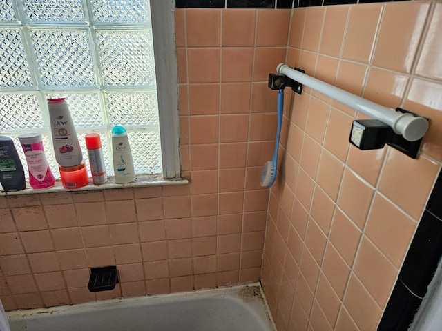 bathroom featuring a tub and walk in shower