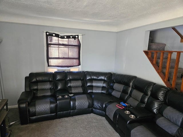 carpeted living room featuring a textured ceiling