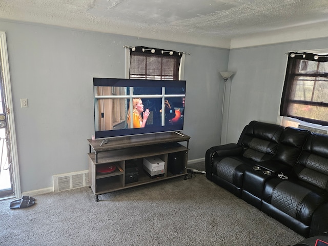 carpeted living area featuring visible vents, a textured ceiling, and a wealth of natural light