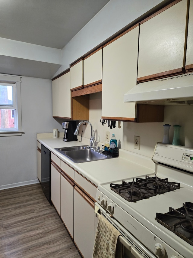 kitchen featuring dishwasher, a sink, light countertops, white gas range oven, and under cabinet range hood