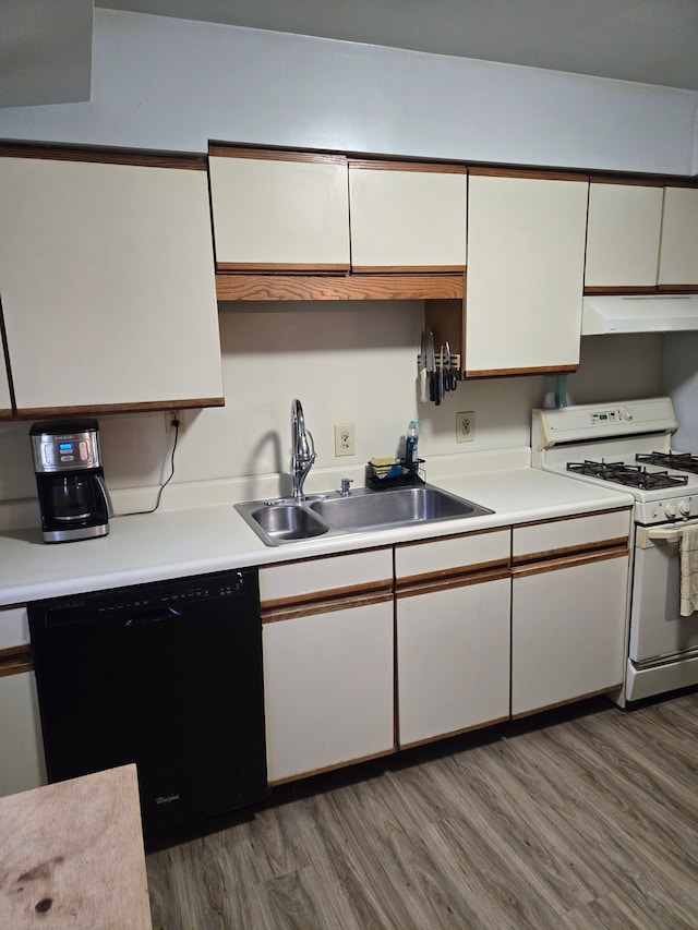 kitchen with white gas stove, white cabinetry, under cabinet range hood, a sink, and dishwasher