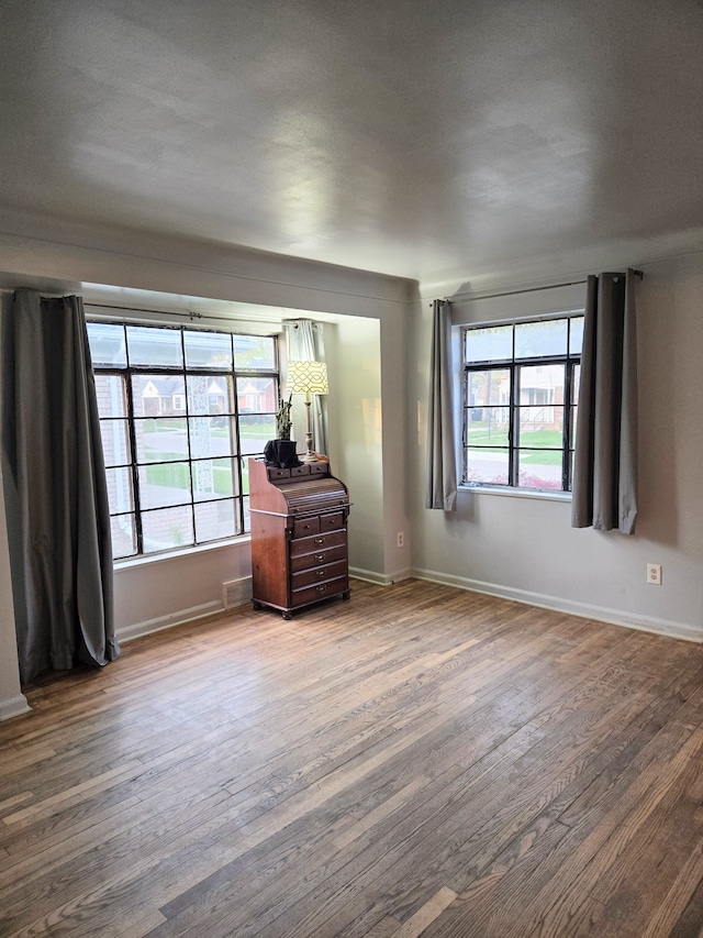 unfurnished bedroom featuring baseboards and wood finished floors