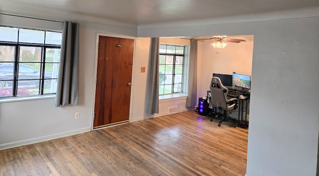 office featuring visible vents, baseboards, plenty of natural light, and wood finished floors