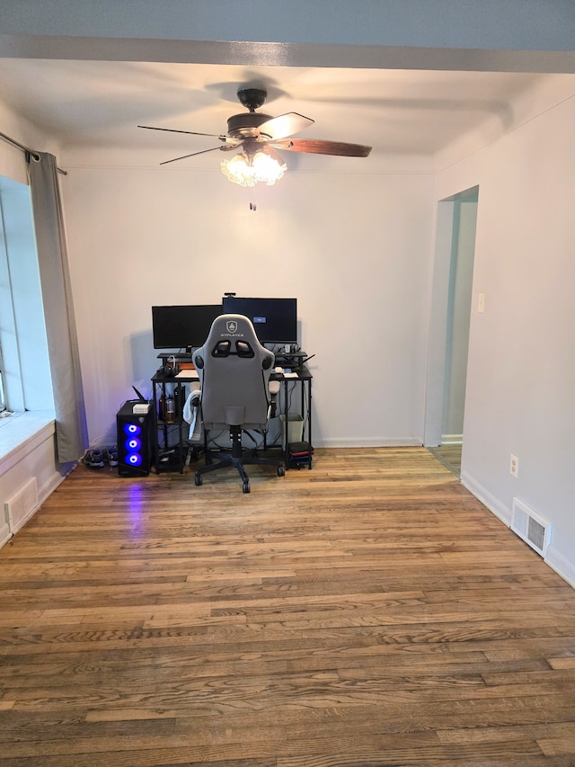office area with baseboards, ceiling fan, and wood finished floors