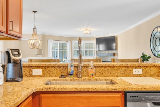 kitchen featuring crown molding, light stone countertops, a sink, dishwasher, and hanging light fixtures