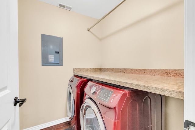 washroom featuring washer and dryer, laundry area, visible vents, and electric panel