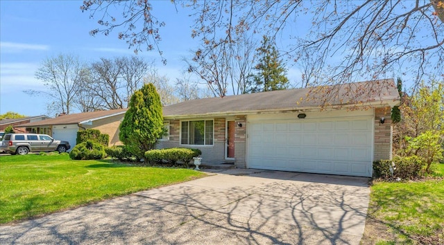 single story home featuring brick siding, a front lawn, an attached garage, and concrete driveway