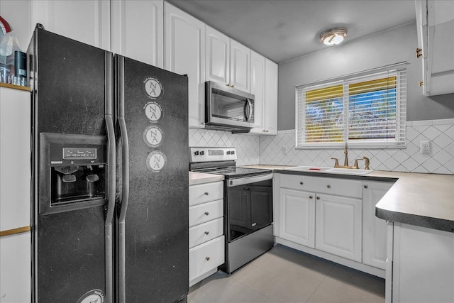 kitchen with light countertops, white cabinetry, appliances with stainless steel finishes, and tasteful backsplash
