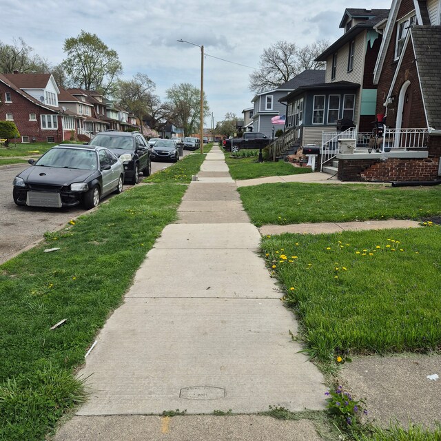 view of road featuring street lighting, a residential view, and sidewalks