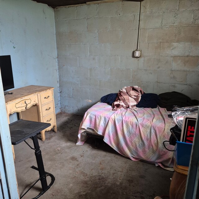 bedroom featuring unfinished concrete floors