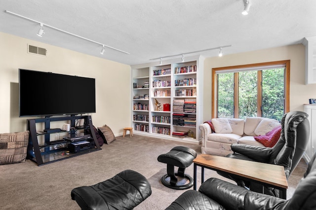 carpeted living room featuring rail lighting and visible vents