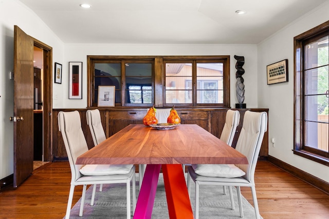 dining space with crown molding, baseboards, recessed lighting, and wood finished floors