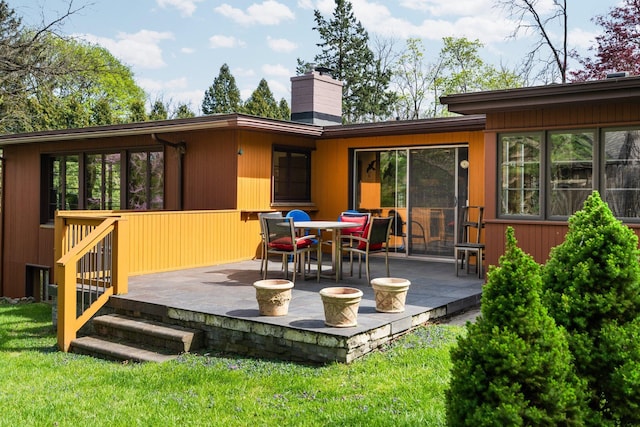 back of house with a patio and a chimney