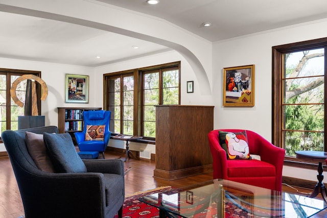 sitting room with visible vents, ornamental molding, wood finished floors, recessed lighting, and arched walkways