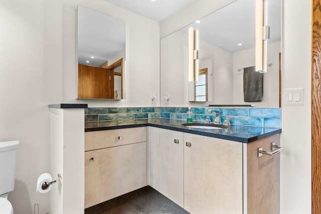 bathroom featuring recessed lighting, vanity, decorative backsplash, and toilet