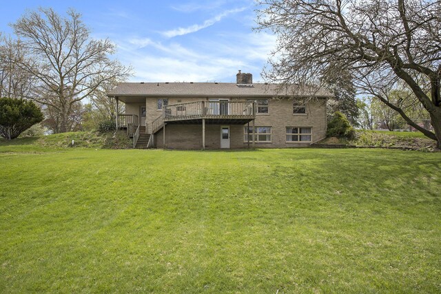back of property with a yard, a deck, a chimney, and stairs