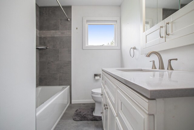 bathroom featuring baseboards, tile patterned floors, vanity, toilet, and tub / shower combination