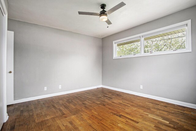 unfurnished room with baseboards, a ceiling fan, and hardwood / wood-style flooring