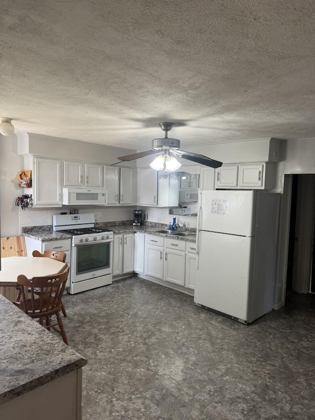 307 N Court St, Stanton, MI 48888 - kitchen with a ceiling fan, white appliances, a textured ceiling, white cabinets, and a sink