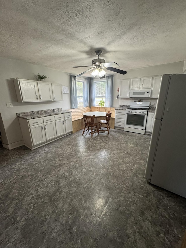 307 N Court St, Stanton, MI 48888 - kitchen featuring a ceiling fan, white cabinetry, a textured ceiling, and white appliances