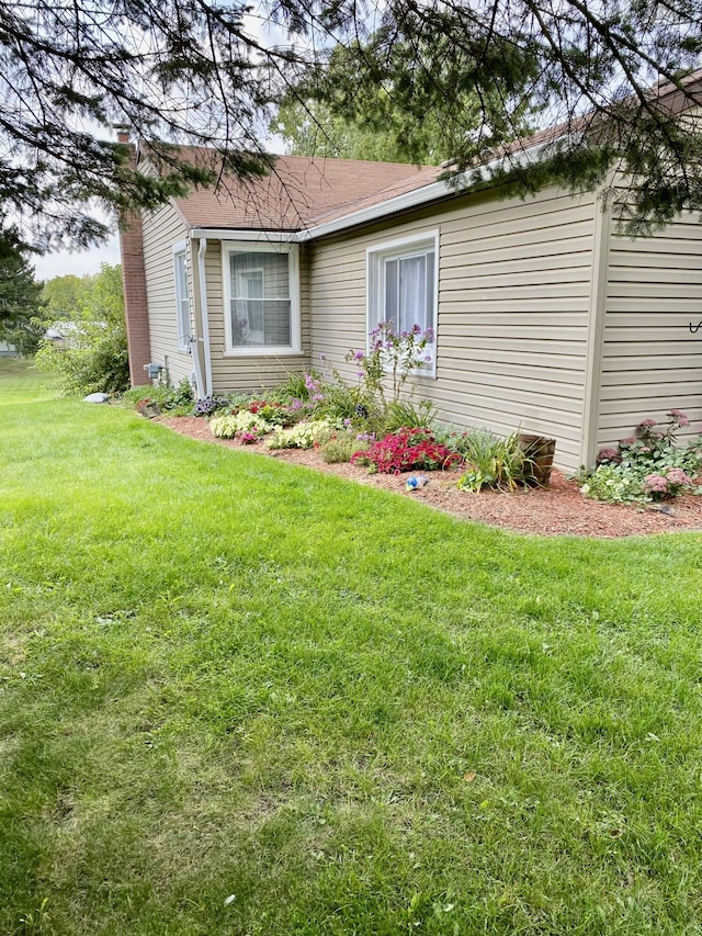 307 N Court St, Stanton, MI 48888 - exterior space featuring a front lawn and a chimney