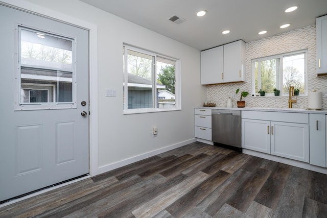 kitchen featuring a sink, plenty of natural light, stainless steel dishwasher, and visible vents