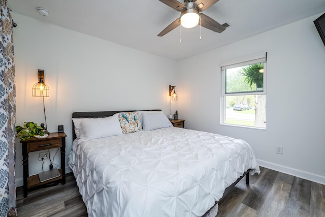 bedroom featuring baseboards, a ceiling fan, wood finished floors, and visible vents
