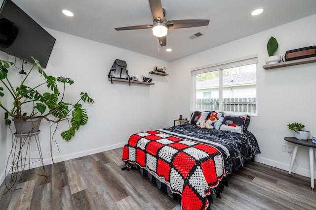 bedroom with baseboards, recessed lighting, wood finished floors, and visible vents