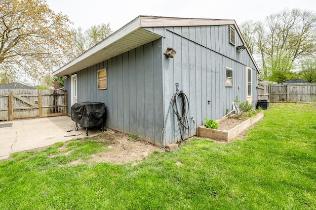 view of outbuilding with central AC unit and a fenced backyard