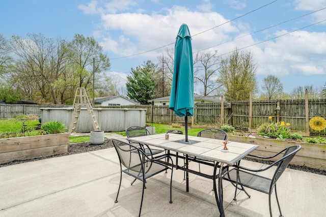 view of patio featuring outdoor dining space and a fenced backyard